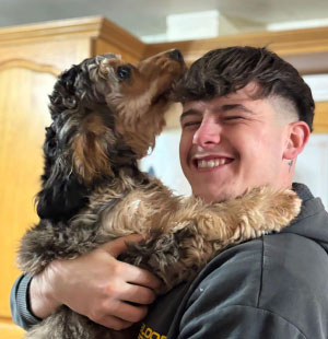 Amy with playful dogs in the field